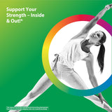 A woman in activewear performs a yoga pose indoors, demonstrating flexibility and balance in a serene setting.