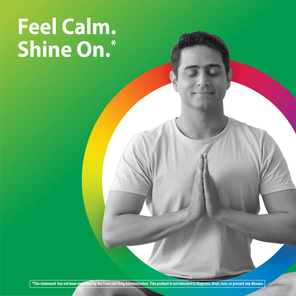 Young adult man meditating with closed eyes and hands in prayer pose, promoting Magnesium 10 Complex for relaxation.