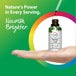 An adult hand holds a Nettle Leaf liquid extract bottle with a dropper dispensing liquid above it.